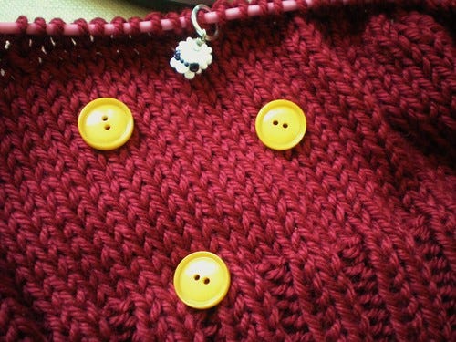 Yellow buttons on knitting Yellow buttons on knitting