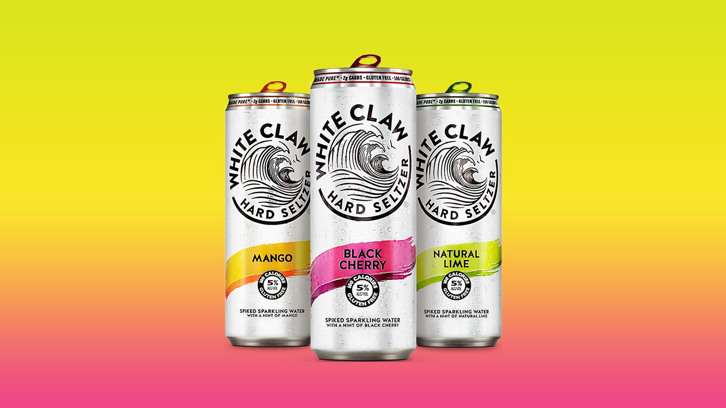 Three White Claw hard seltzer cans on a colorful background Three White Claw hard seltzer cans on a colorful background