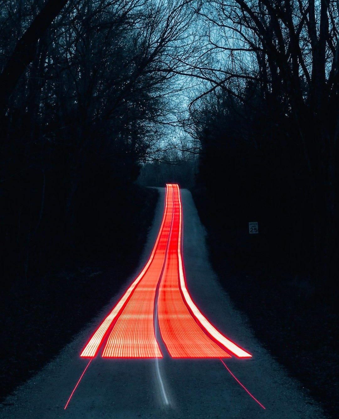 a long exposure photograph of a road at night