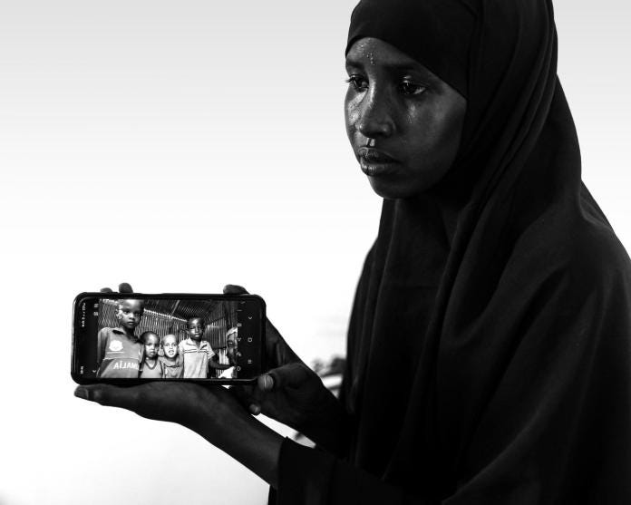 Qaali Dahir Mohamed, 18 yrs old Luley's full-sister, shows a selfie picture of her with her nephew Mohamed Amin (right) and other children through her mobile in Mogadishu, Somalia, Wednesday, May. 10, 2023. ( Omar Faruk for The Intercept) Qaali Dahir Mohamed, 18 yrs old Luley's full-sister, shows a selfie picture of her with her nephew Mohamed Amin (right) and other children through her mobile in Mogadishu, Somalia, Wednesday, May. 10, 2023. ( Omar Faruk for The Intercept)