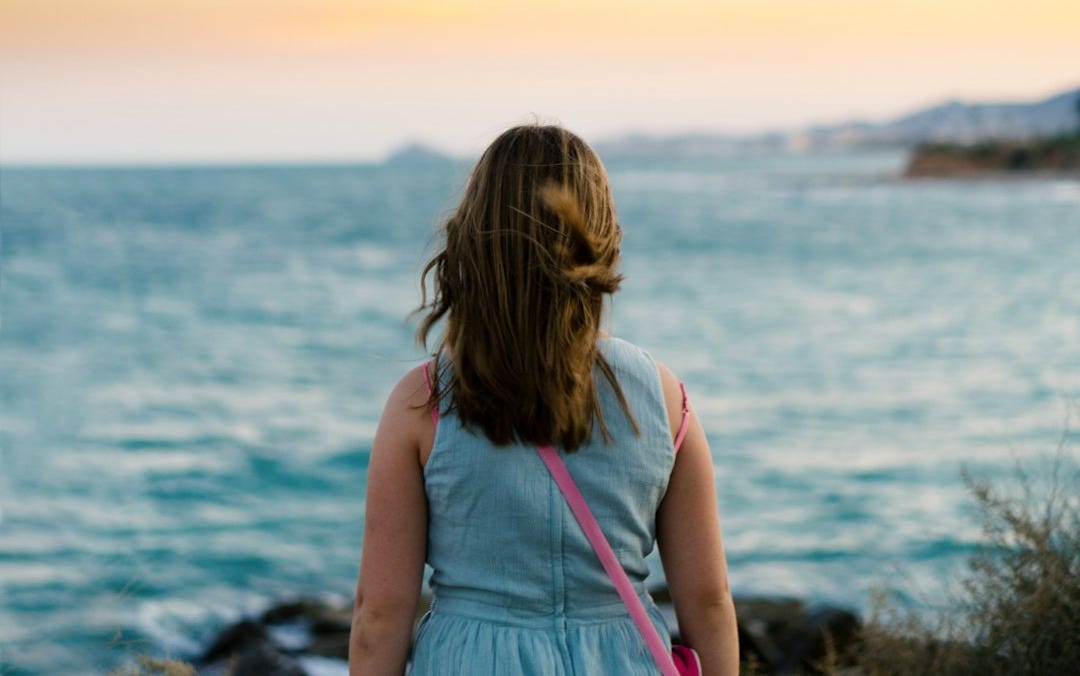 woman standing near body of water