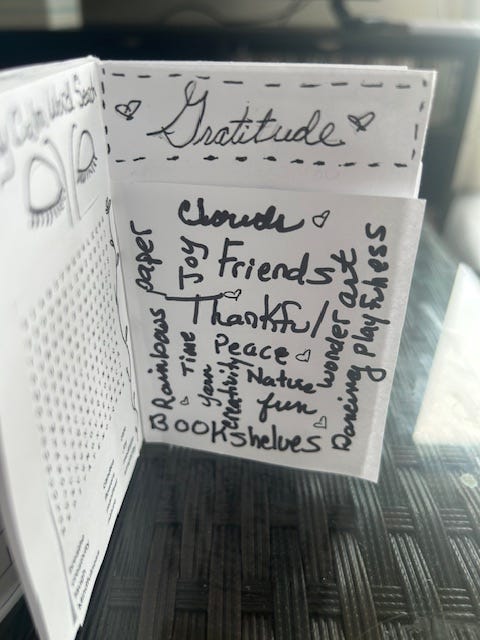 Black and white magazine with a gratitude cloud of words on one side and a word-search puzzle on the other