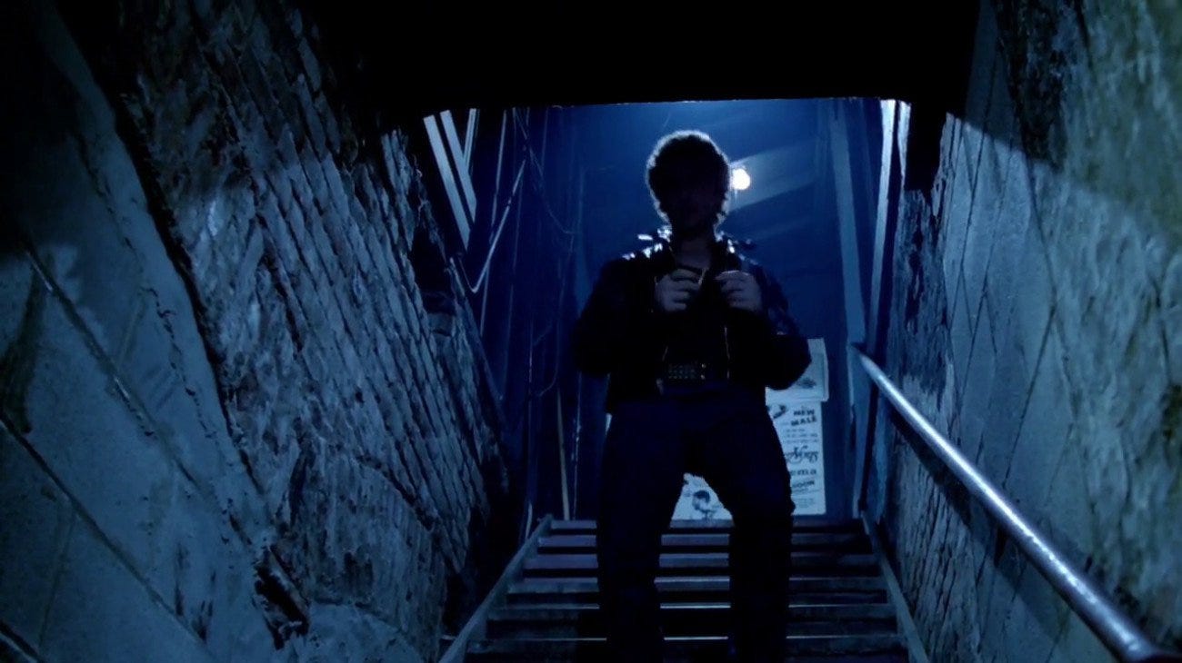 Al Pacino's silhouette, clad in leather, walks down stairs into a leather sex club. Al Pacino's silhouette, clad in leather, walks down stairs into a leather sex club.