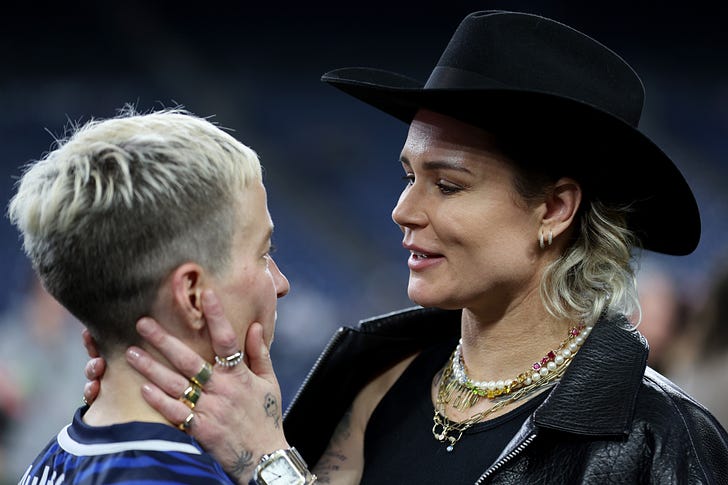 The Ashlyn Harris/Megan Rapinoe interaction is A LOT, as is Ashlyn's hat. (Photo by Steph Chambers/Getty Images)