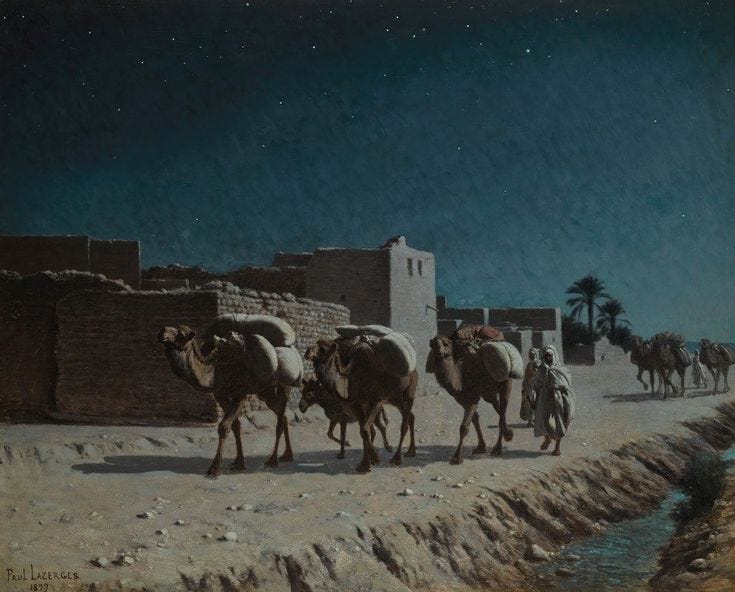 This may contain: a group of camels walking down a dirt road next to a brick building and palm trees