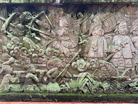 rooster, cement carvings, trees, walking paths through a park