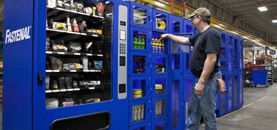 Fastenal vending machine with man selecting item Fastenal vending machine with man selecting item