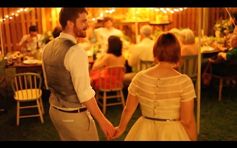 Three warm screenshots from our wedding video in our backyard.