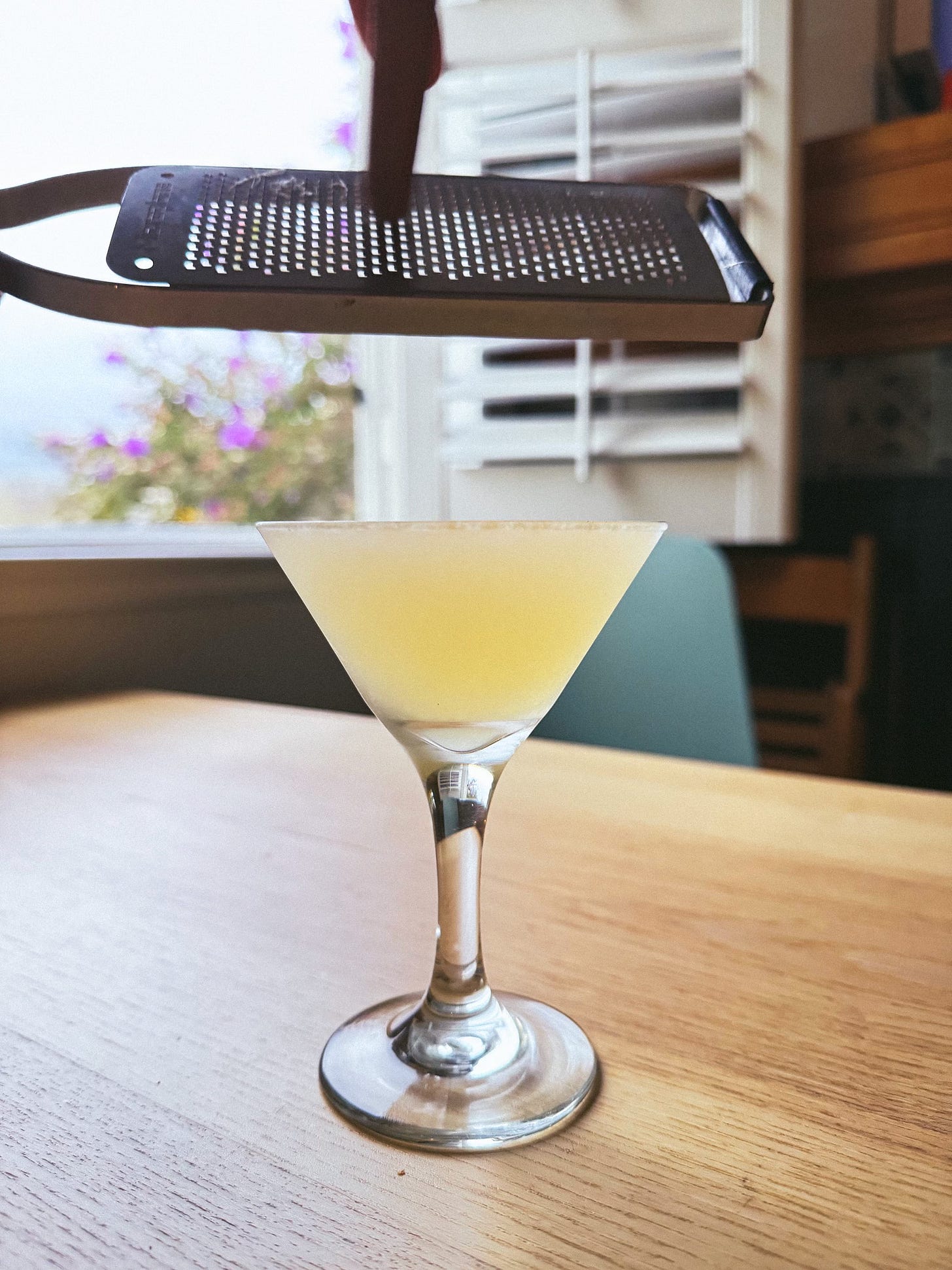 Grating cinnamon into a cocktail