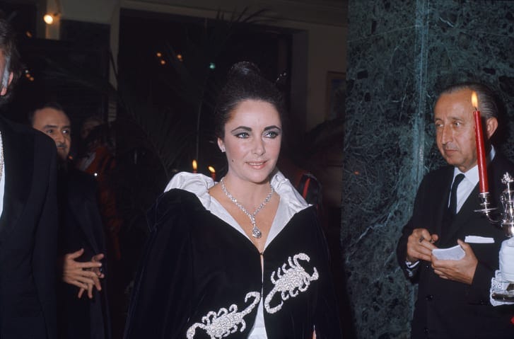 Elizabeth Taylor, a Pisces with a Scorpio husband, was admitted to the event and arrived in a velvet black cloak with Scorpio motif. Elizabeth Taylor, a Pisces with a Scorpio husband, was admitted to the event and arrived in a velvet black cloak with Scorpio motif.