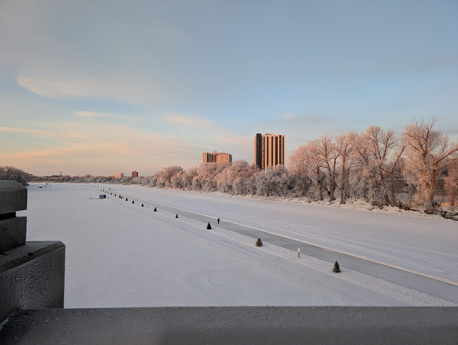skyline view of frozen river and hoarfrost trees skyline view of frozen river and hoarfrost trees