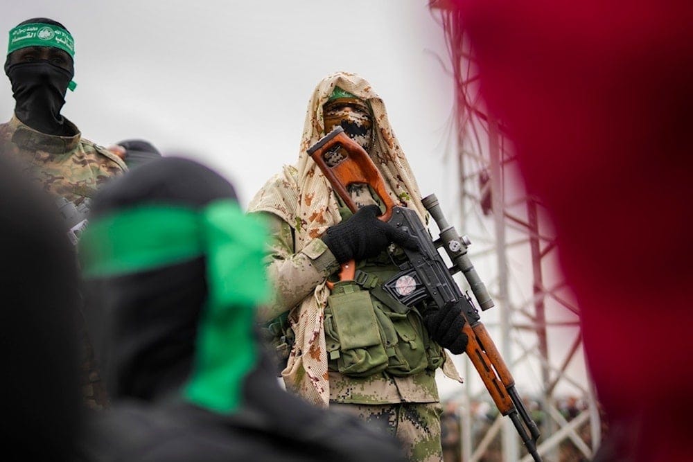 A Hamas fighter in combat fatigues stands before the ceremony for the handover of Israeli captives to the Red Cross in Nuseirat, central Gaza Strip, Saturday, Feb. 22, 2025 (AP)