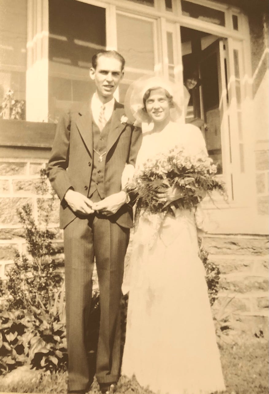 A person and person standing outside a house

Description automatically generated