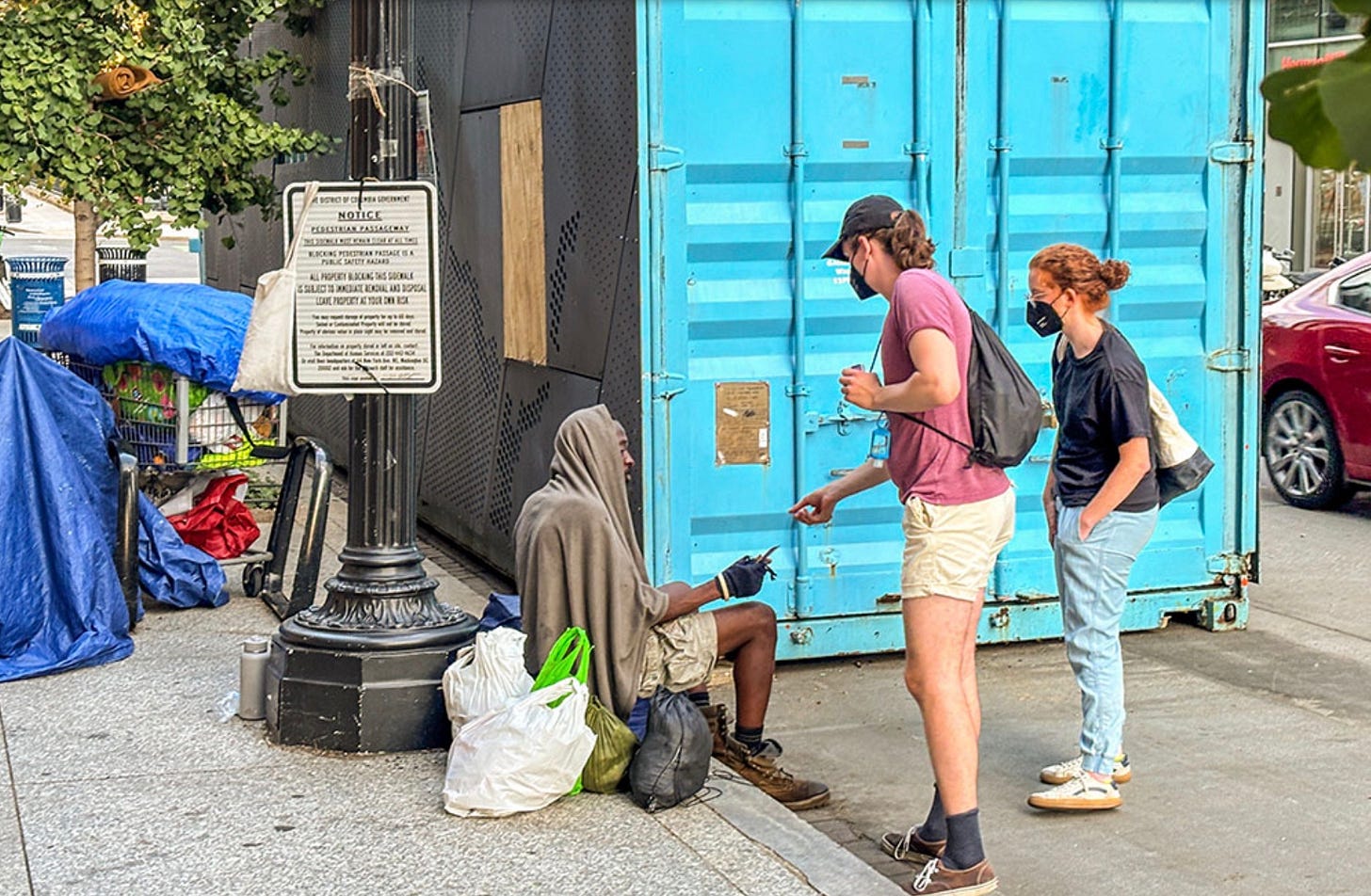 A group of people standing on the sidewalk

AI-generated content may be incorrect.