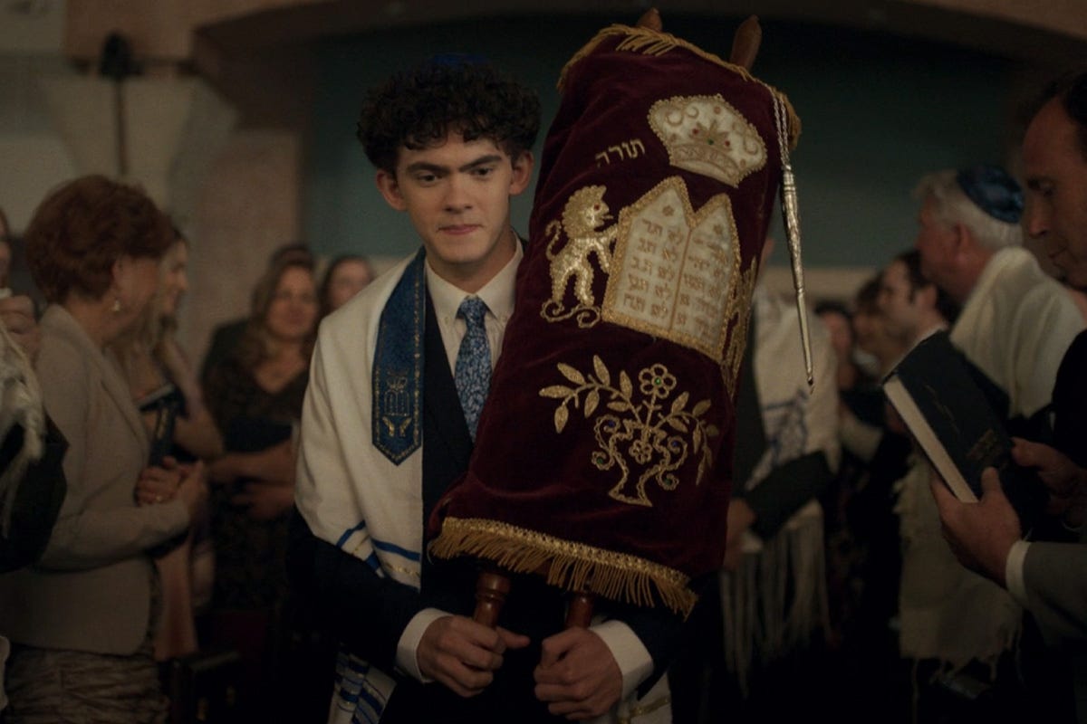 An image of Joe Lock as Teen in Agatha All Along, carrying the Torah.