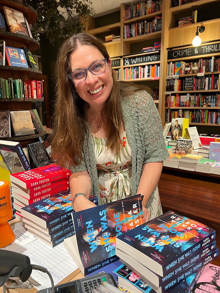 Sara Foster and Joanna Morrison are on a small stage, holding up Sara Foster's new thriller, 'When She Was Gone'. In other pictures, Sara is signing copies of her book, a hand is holding up a copy for the camera, and an audience is watching the event.