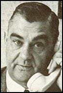 A person with his hand on his head

Description automatically generated