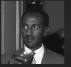 A person in a suit holding a drink

AI-generated content may be incorrect.