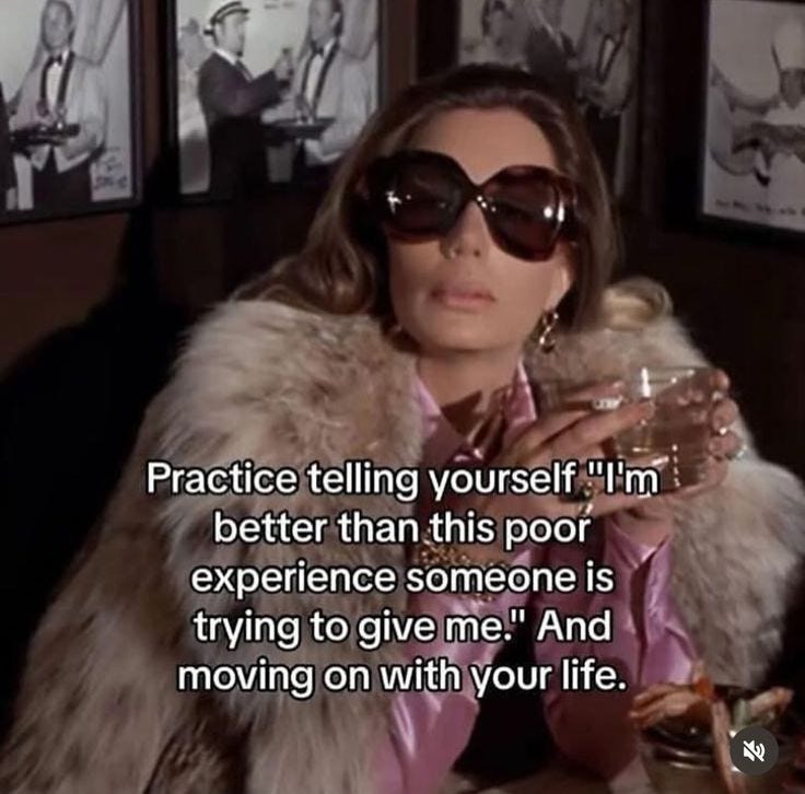 This may contain: a woman wearing sunglasses and a fur coat sitting at a table in front of pictures