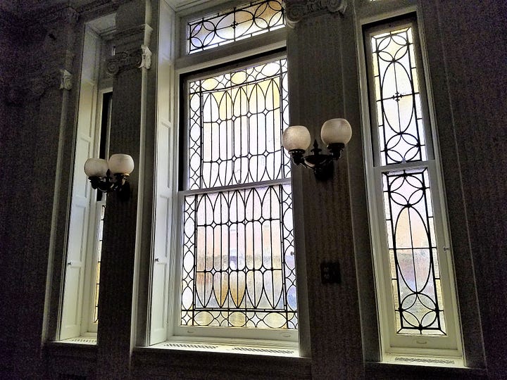 An elaborate window and a marble fireplace inside Laburnum.
