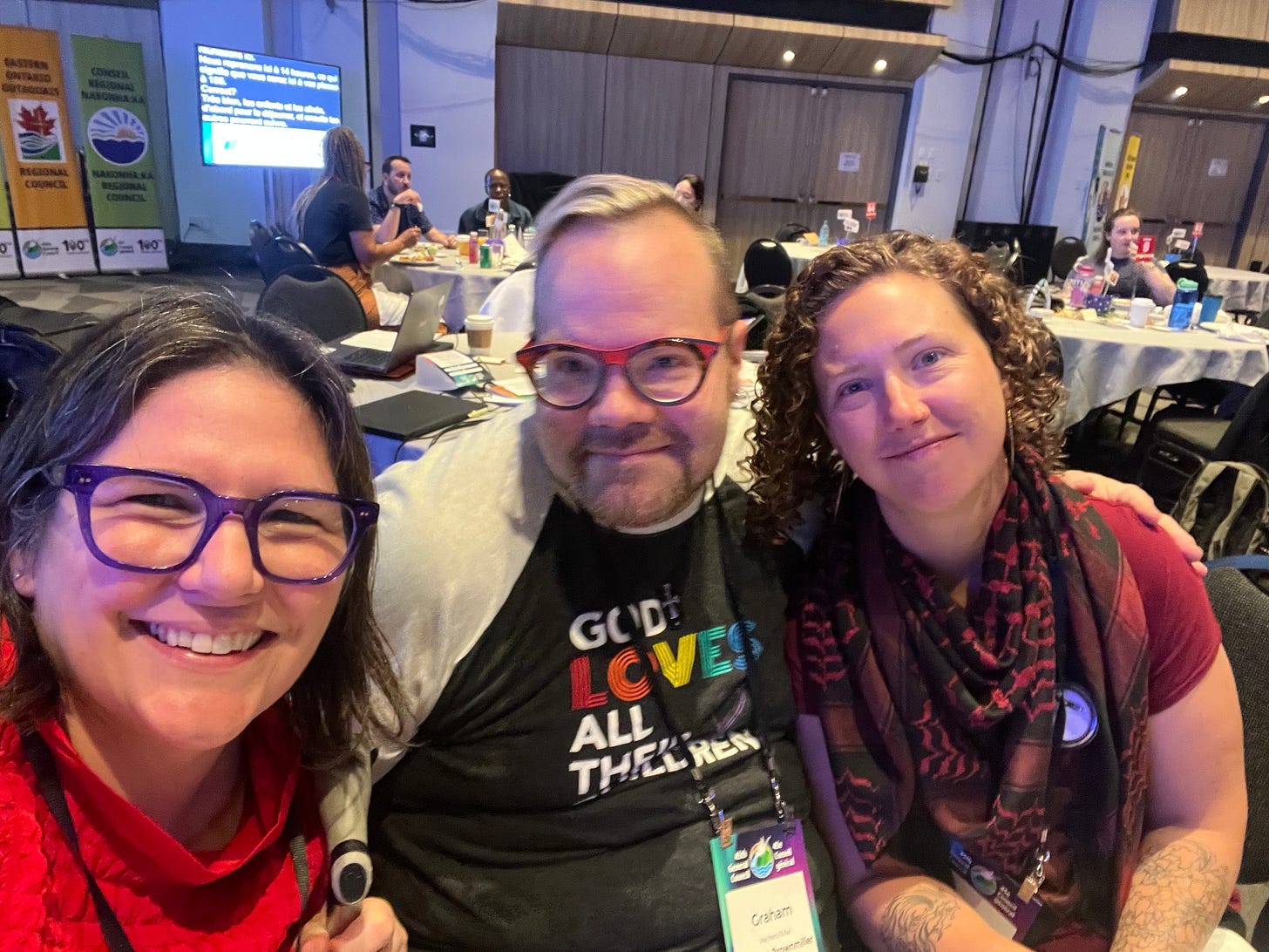 3 friends at a large meeting in a convention center
