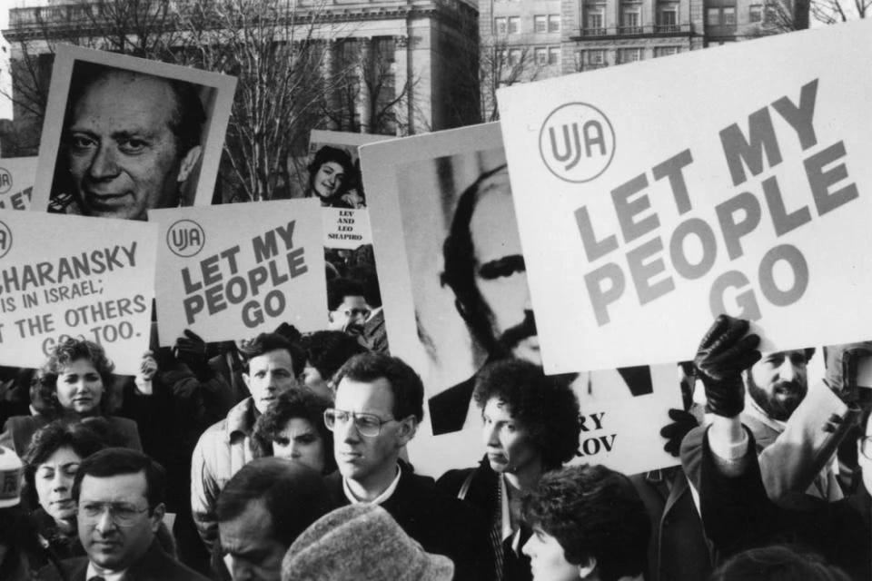 Black-and-white photo of protesters at the 1987 Freedom Sunday March for Soviet Jews in Washington, D.C., holding signs with slogans like “Let My People Go” and images of Refusenik leaders such as Natan Sharansky. Black-and-white photo of protesters at the 1987 Freedom Sunday March for Soviet Jews in Washington, D.C., holding signs with slogans like “Let My People Go” and images of Refusenik leaders such as Natan Sharansky.