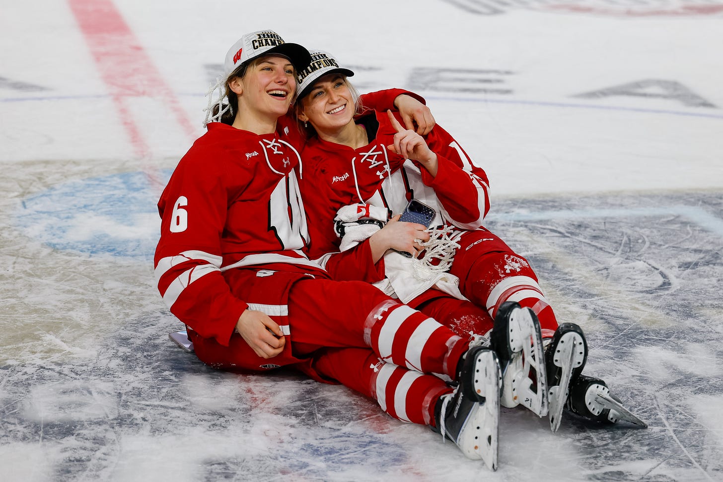 Wisconsin badgers forward Lacey Eden and Claire Enright sit at center ice