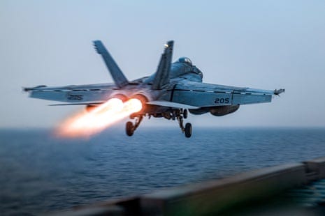 US fighter jet rolls off aircraft carrier as ship reportedly swerves Houthi  fire | US military | The Guardian