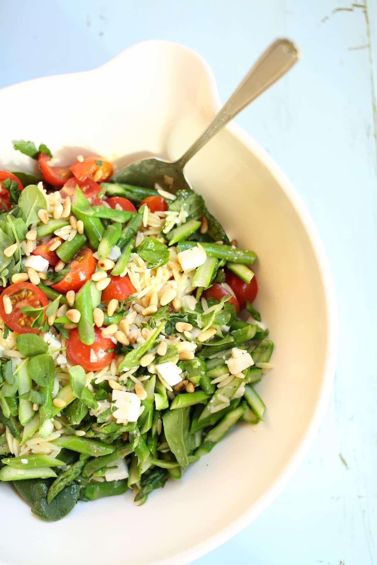 a white bowl full of pasta salad