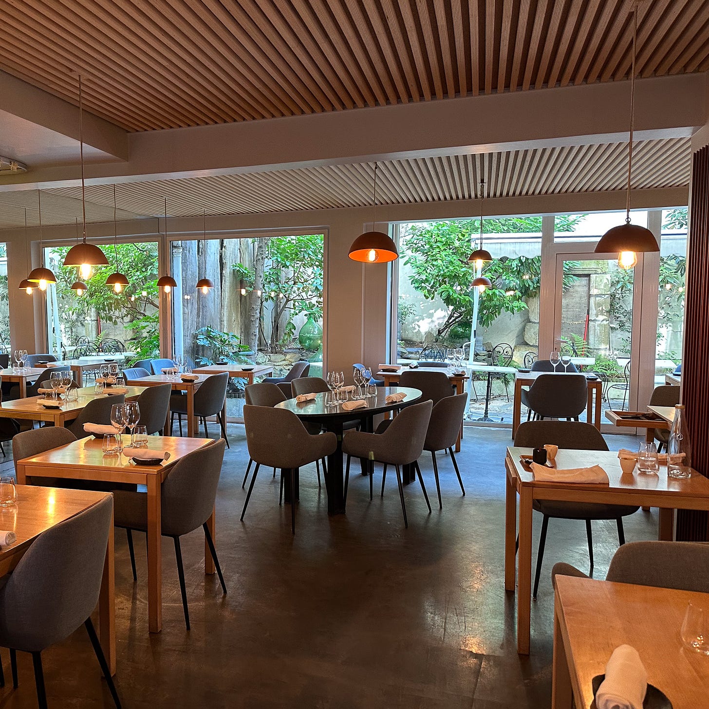 Dining room with outdoor garden at La Table de Colette restaurant in the Latin Quarter of Paris