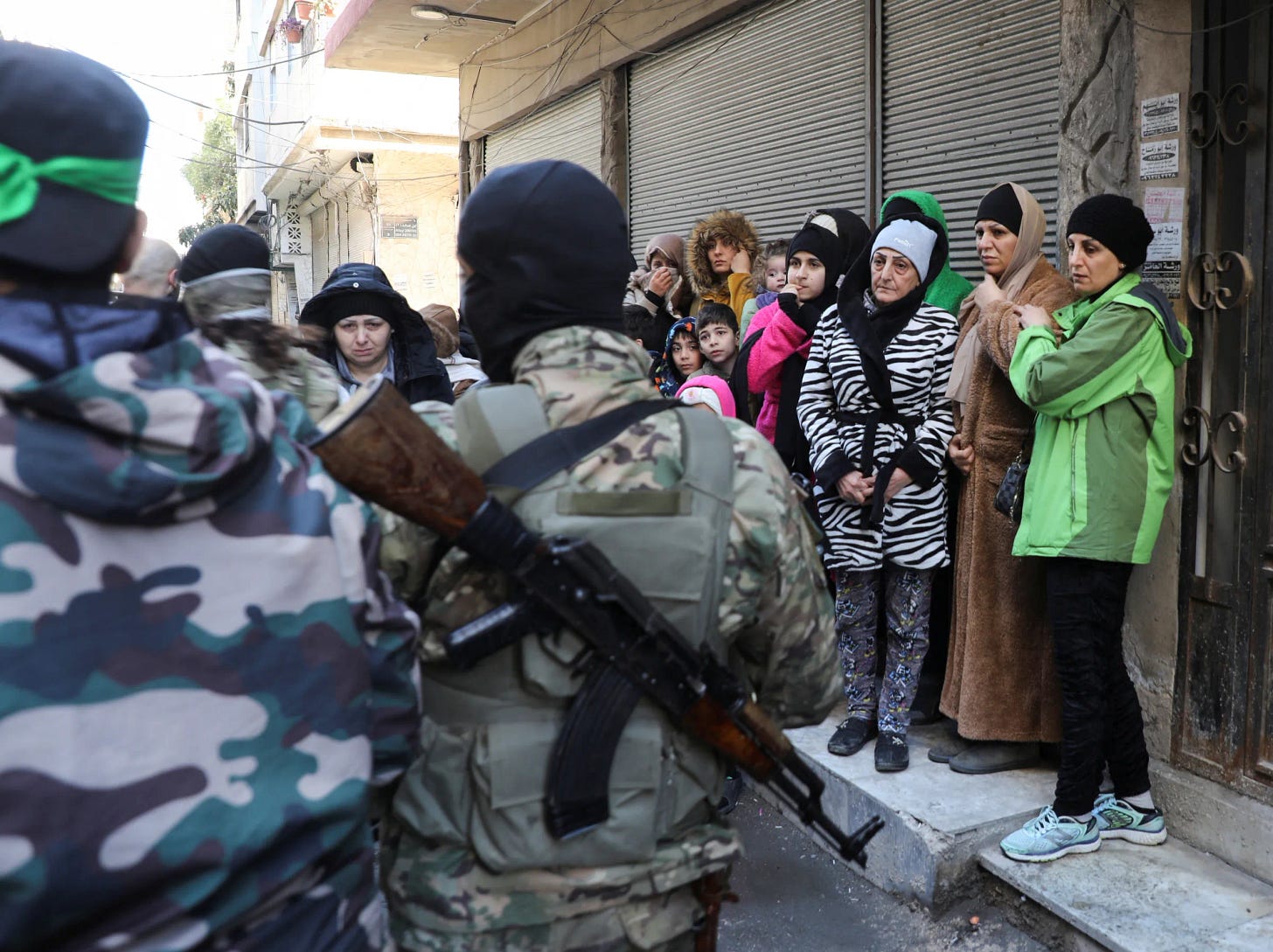 People gather near fighters of Hayat Tahrir al-Sham (HTS) during what HTS said was security checks to find 'remnants' of ousted Syrian President Bashar al-Assad's force, in Wadi al-Dahab neighbourhood in Homs, Syria January 2, 2025. REUTERS/Khalil Ashawi People gather near fighters of Hayat Tahrir al-Sham (HTS) during what HTS said was security checks to find 'remnants' of ousted Syrian President Bashar al-Assad's force, in Wadi al-Dahab neighbourhood in Homs, Syria January 2, 2025. REUTERS/Khalil Ashawi