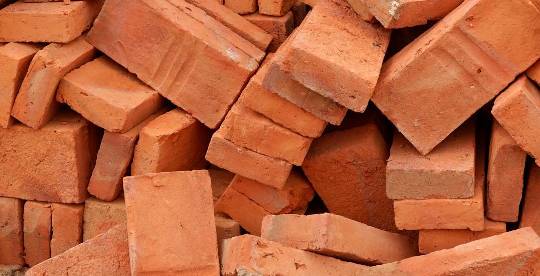 A pile of red bricks sitting next to each other