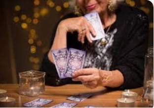 A person holding cards in front of a table

AI-generated content may be incorrect.