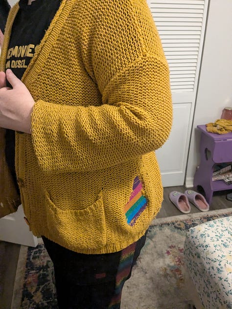Several photos of a jewel-toned cross stitch patch on the same yellow sweater.