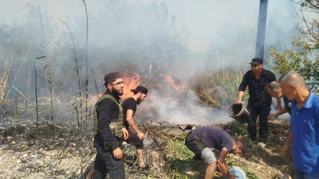 May be an image of 5 people, fire and grass May be an image of 5 people, fire and grass