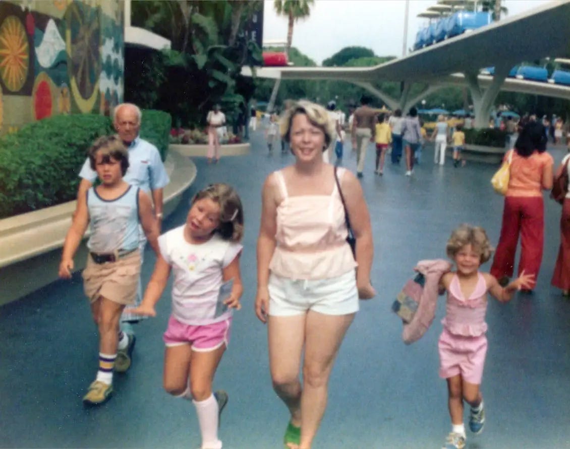 Kim Doyal as a child with her mom, brother, and sister walking through a nearly empty Disneyland in 1978, all smiling in matching summer outfits