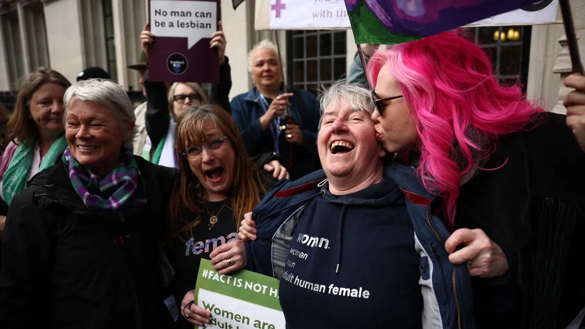 Activists celebrating a Supreme Court ruling on the legal definition of "woman." Activists celebrating a Supreme Court ruling on the legal definition of "woman."