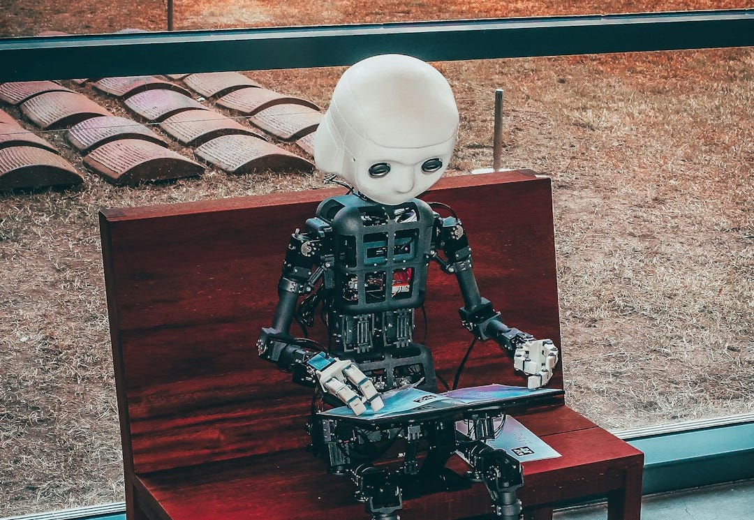 black and white robot toy on red wooden table