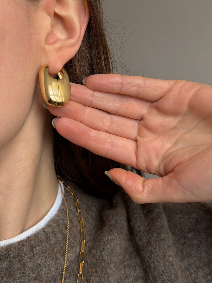 Laura Lombardi vola hoops, sezane irma link chain and monica vinader fine chain necklace and pendant in gold.