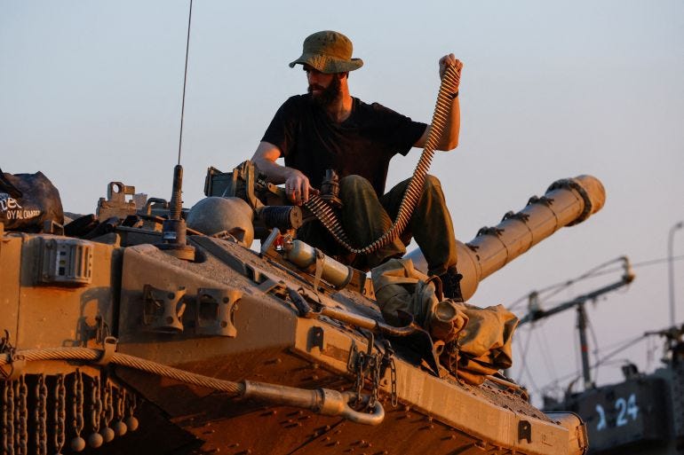 An Israeli soldier reloads the machine gun of tank Merkava, amid a temporary truce between Hamas and Israel, near Gaza, in South Israel, November 30, 2023. REUTERS/Alexander Ermochenko TPX IMAGES OF THE DAY An Israeli soldier reloads the machine gun of tank Merkava, amid a temporary truce between Hamas and Israel, near Gaza, in South Israel, November 30, 2023. REUTERS/Alexander Ermochenko TPX IMAGES OF THE DAY