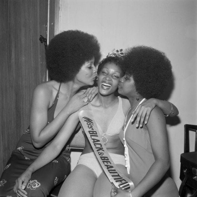 This may contain: three women sitting next to each other in front of a mirror This may contain: three women sitting next to each other in front of a mirror