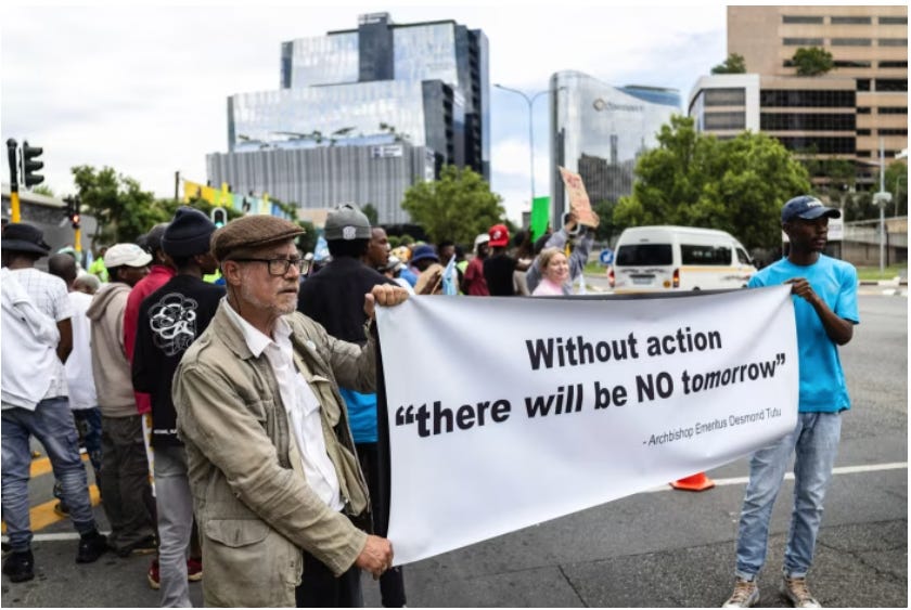 A person holding a banner

Description automatically generated