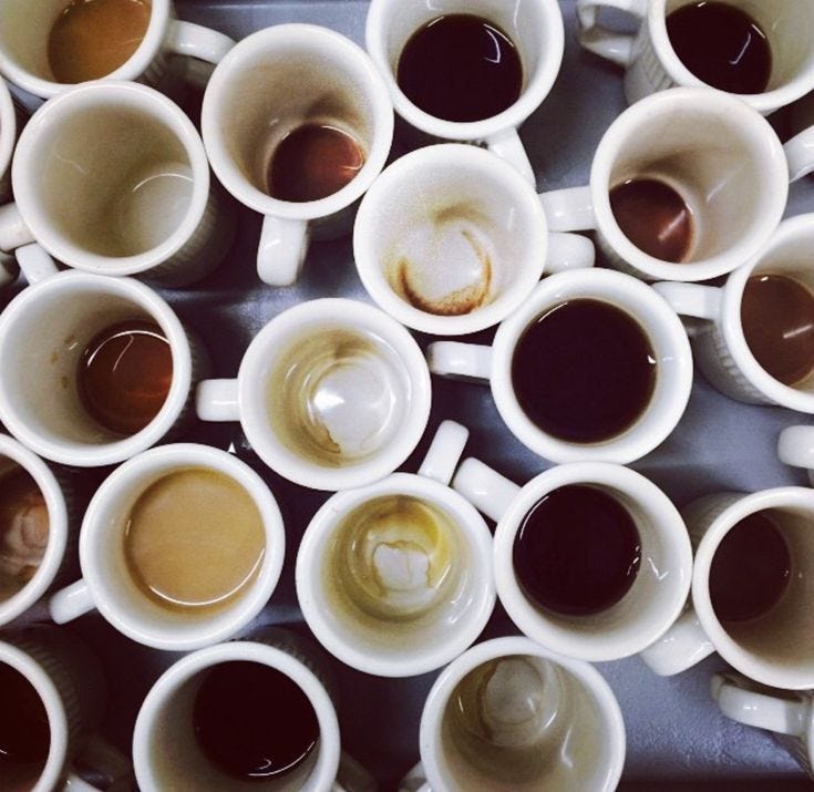 This may contain: many cups of coffee are lined up together