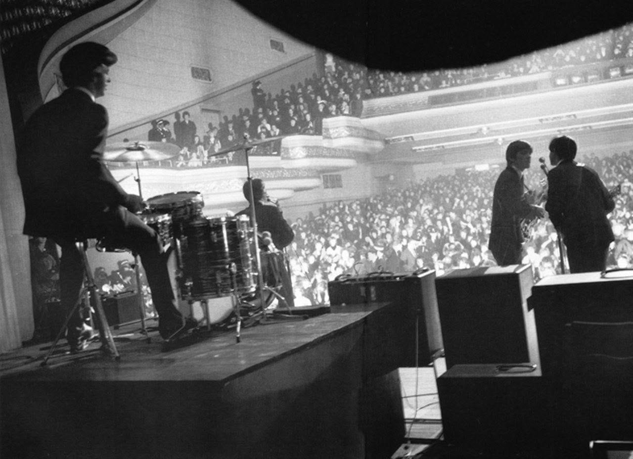 May be a black-and-white image of 4 people, people standing, people playing musical instruments and indoor