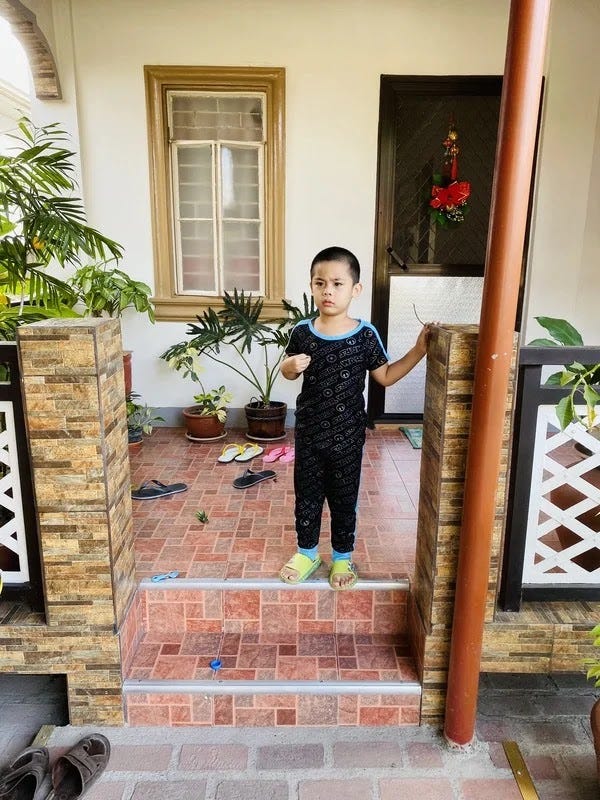 Little boy standing on the terrace steps