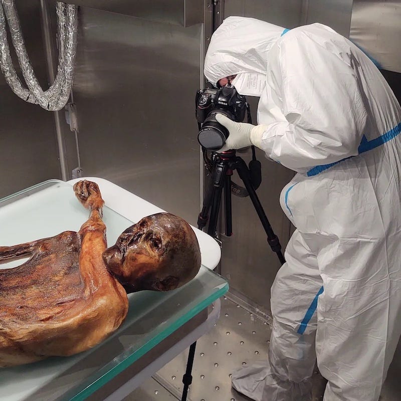 One of the three archaeologists photographing Ötzi in the sterile laboratory chamber. The shoot ran for nearly six hours.