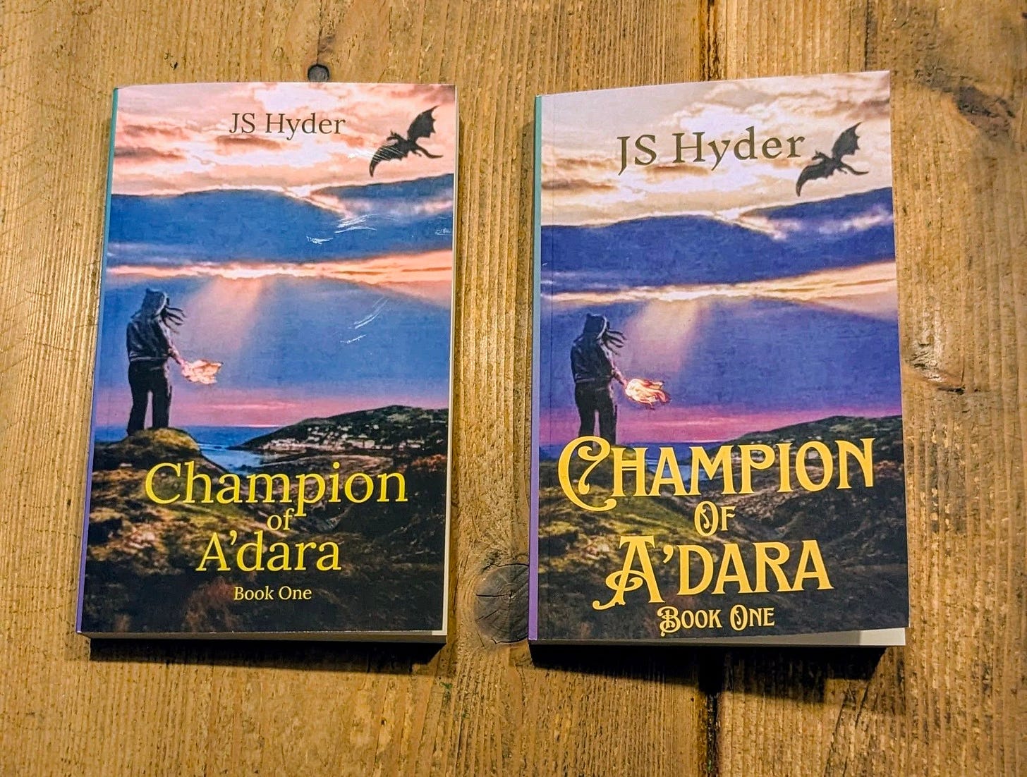 Champion of A'dara paperback side by side one on right has fancier fonts Champion of A'dara paperback side by side one on right has fancier fonts