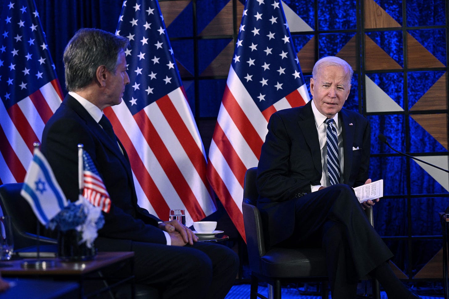 US Secretary of State Antony Blinken (L) sits with US President Joe Biden as they meet with Israel's Prime Minister in Tel Aviv on October 18, 2023, amid the ongoing battles between Israel and the Palestinian group Hamas. US President Joe Biden landed in Tel Aviv on October 18, 2023 as Middle East anger flared after hundreds were killed when a rocket struck a hospital in war-torn Gaza, with Israel and the Palestinians quick to trade blame. (Photo by Brendan SMIALOWSKI / AFP) (Photo by BRENDAN SMIALOWSKI/AFP via Getty Images)