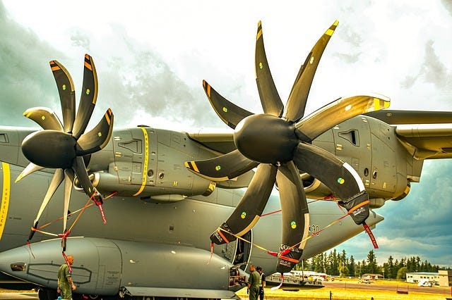 Graphic of the back end of a military plane with eight-bladed propellers Graphic of the back end of a military plane with eight-bladed propellers