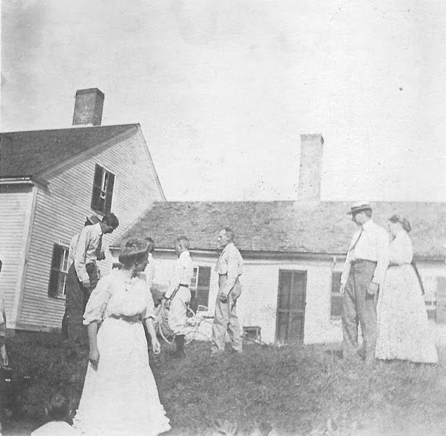 Group of people in front of house